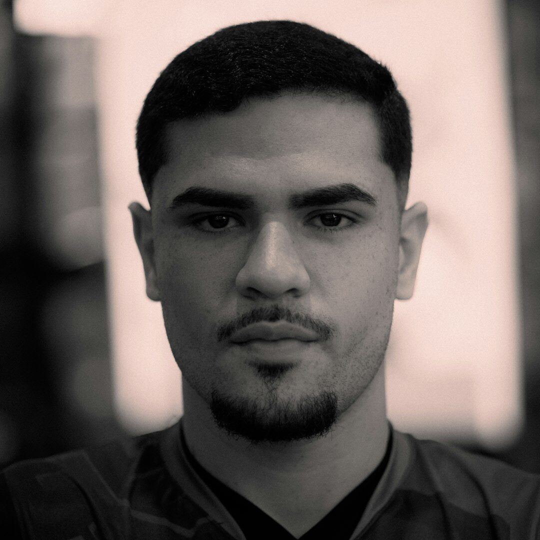 Studio portrait of a Latino man in his 30s, editor in chief